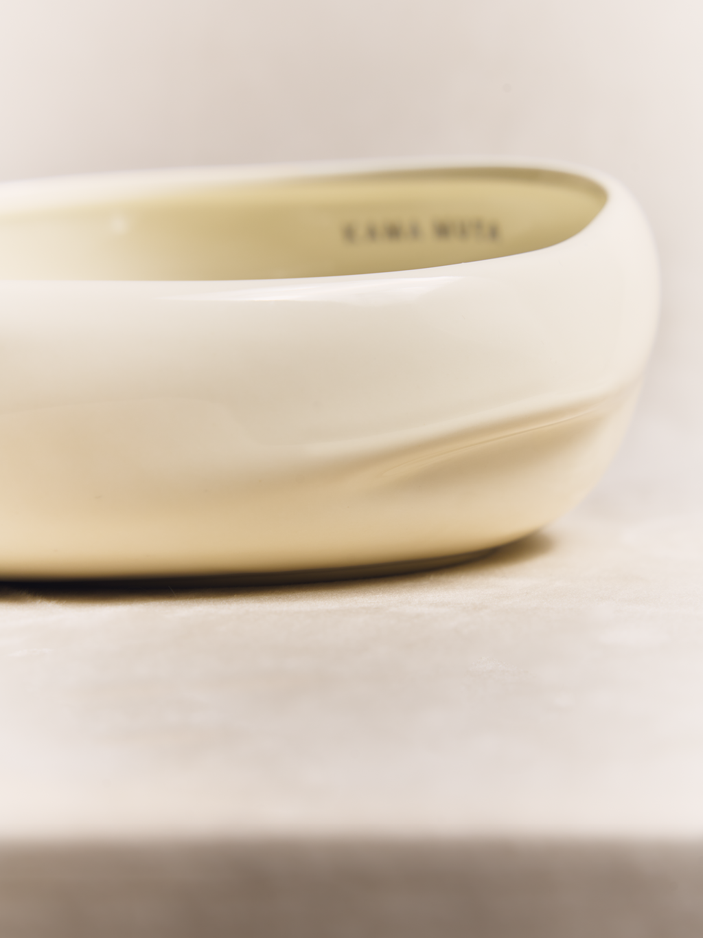 Ceramic pet bowl by KAMA MUTA with a glossy finish and cute paw print design, ideal for dogs or cats.