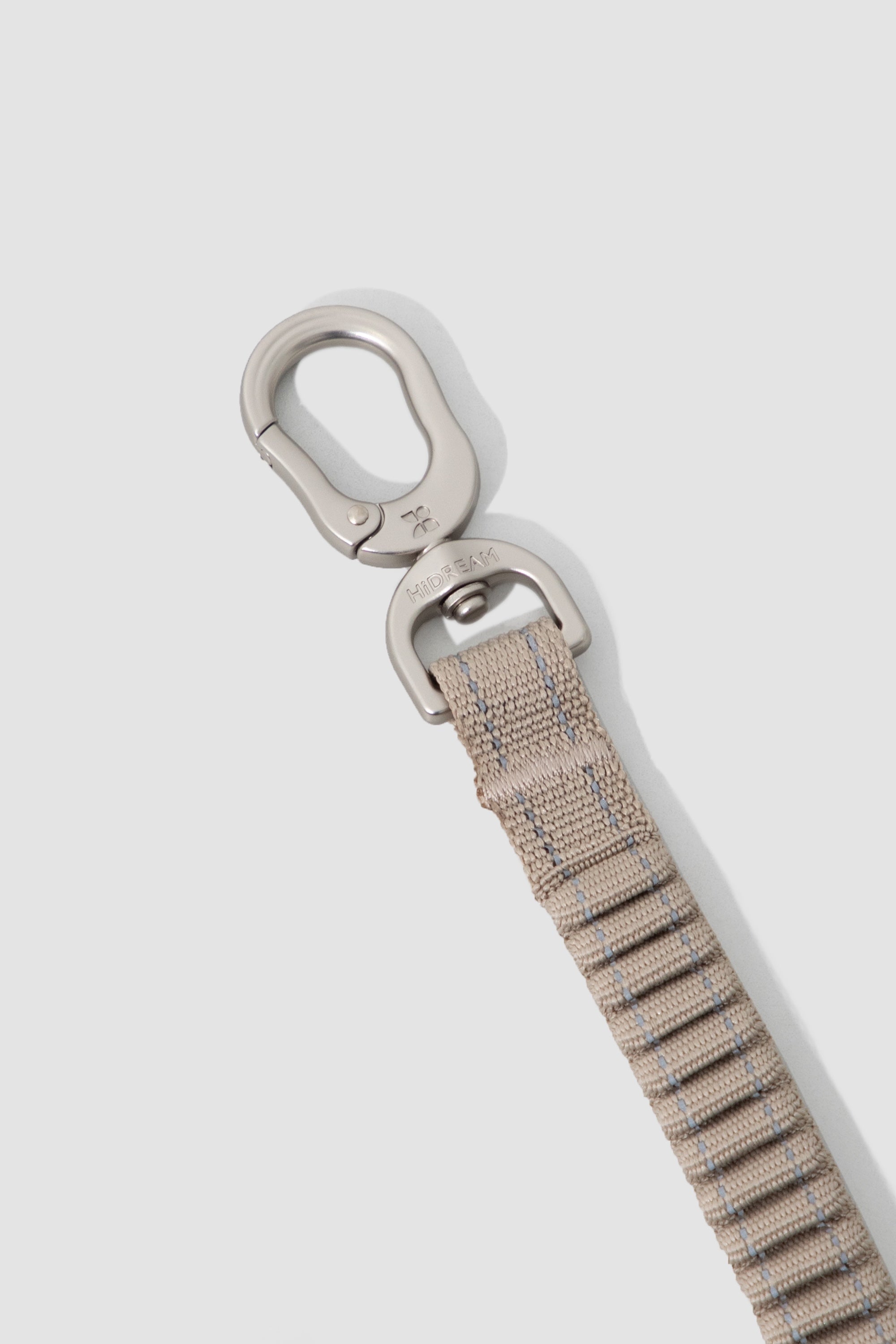Close-up of the 360-degree swivel metal hook on a dog car seatbelt tether, designed to prevent tangling and accidental release.