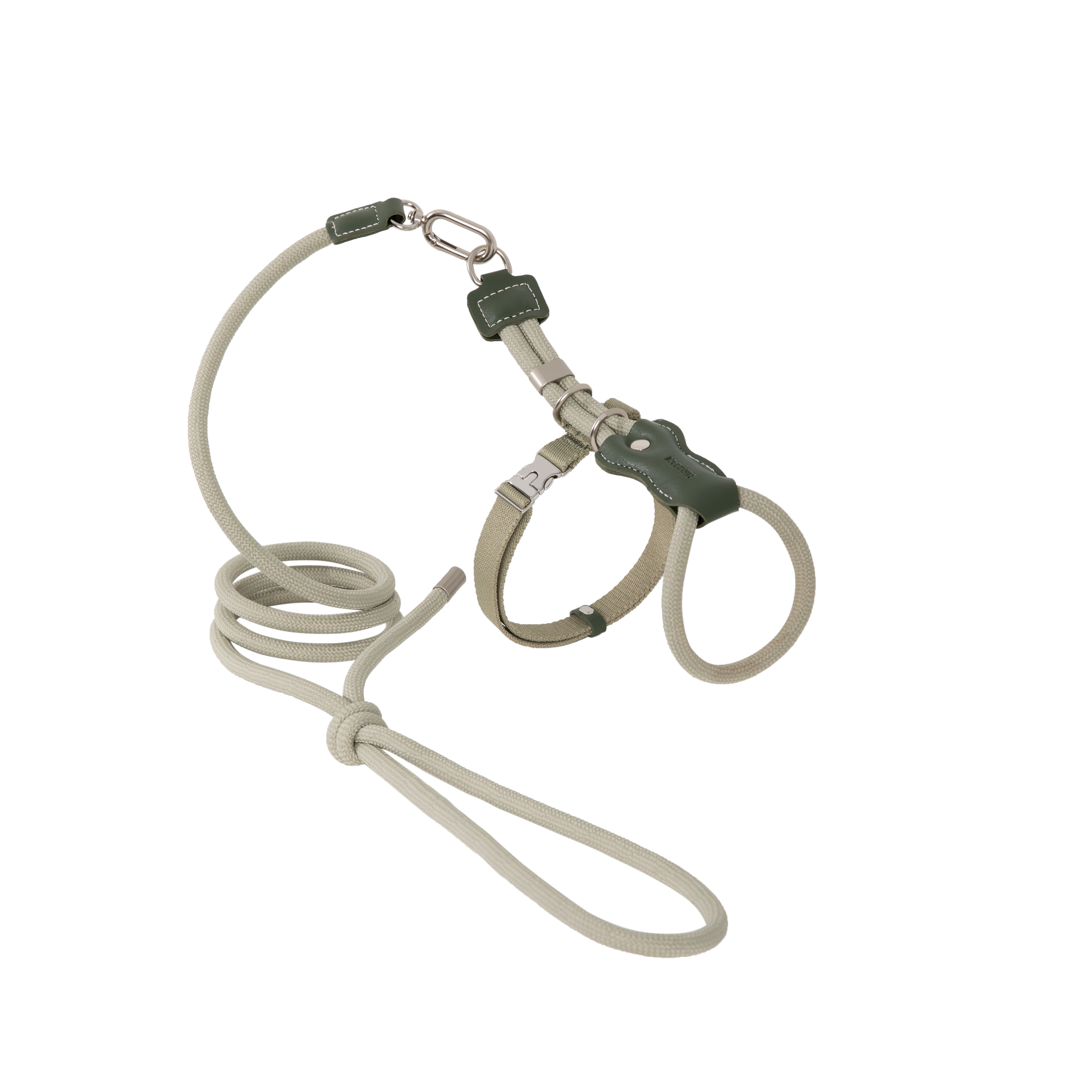 Flat lay of a green adjustable cat harness and leash set, showing the sliding back adjustment and rope leash length.
