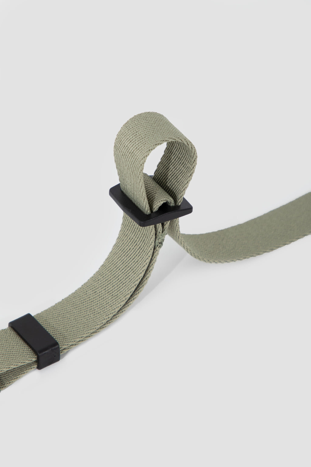 Close-up of the adjustable length slider on a dog car seatbelt tether, showing how the webbing length can be easily adjusted.