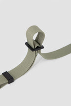 Close-up of the adjustable length slider on a dog car seatbelt tether, showing how the webbing length can be easily adjusted.