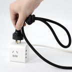 Hand holding the rope leash to show knot structure, grip feel, and tension response