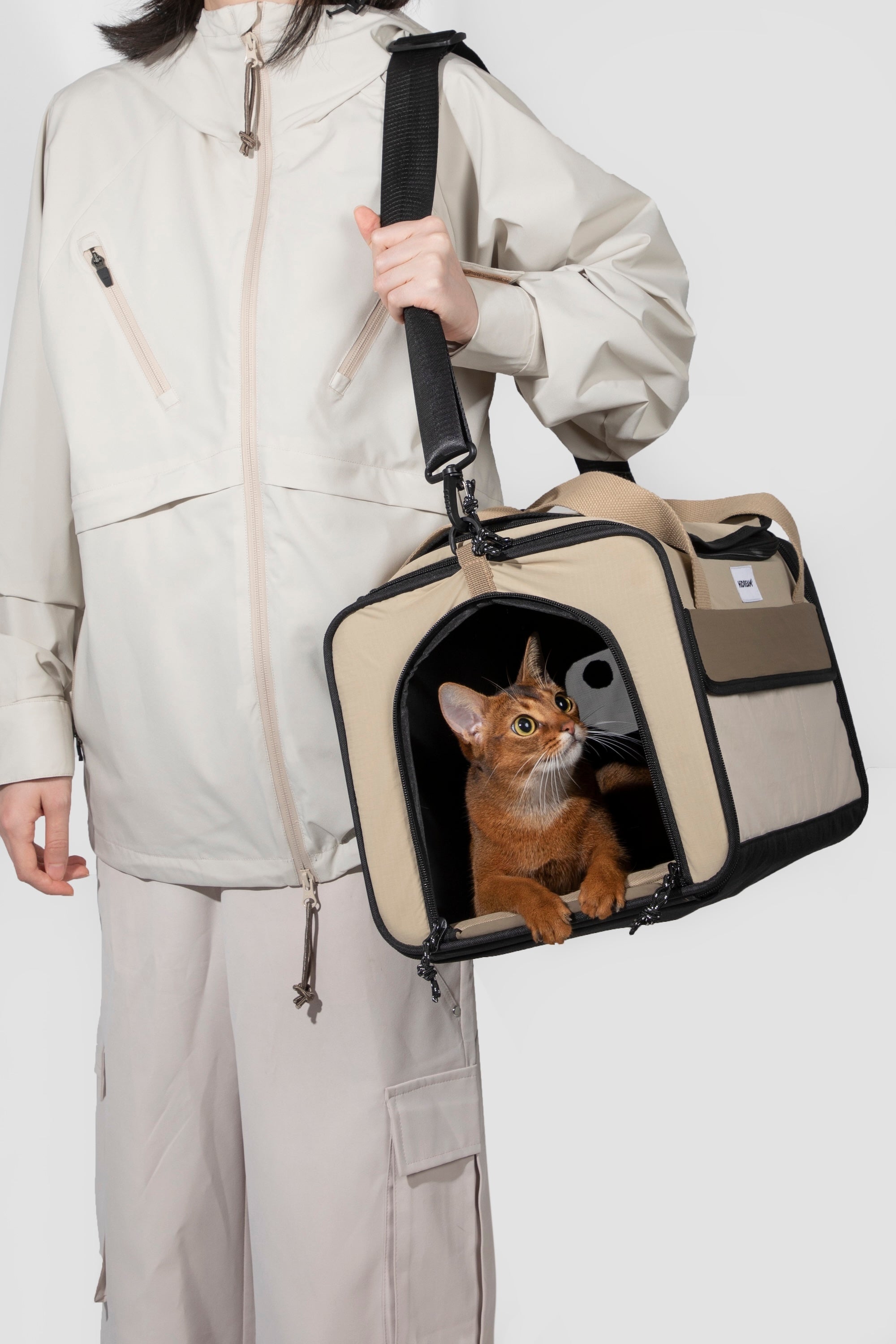 Handheld airline pet carrier with the front door opened, showing easy entry and exit for pets during travel.