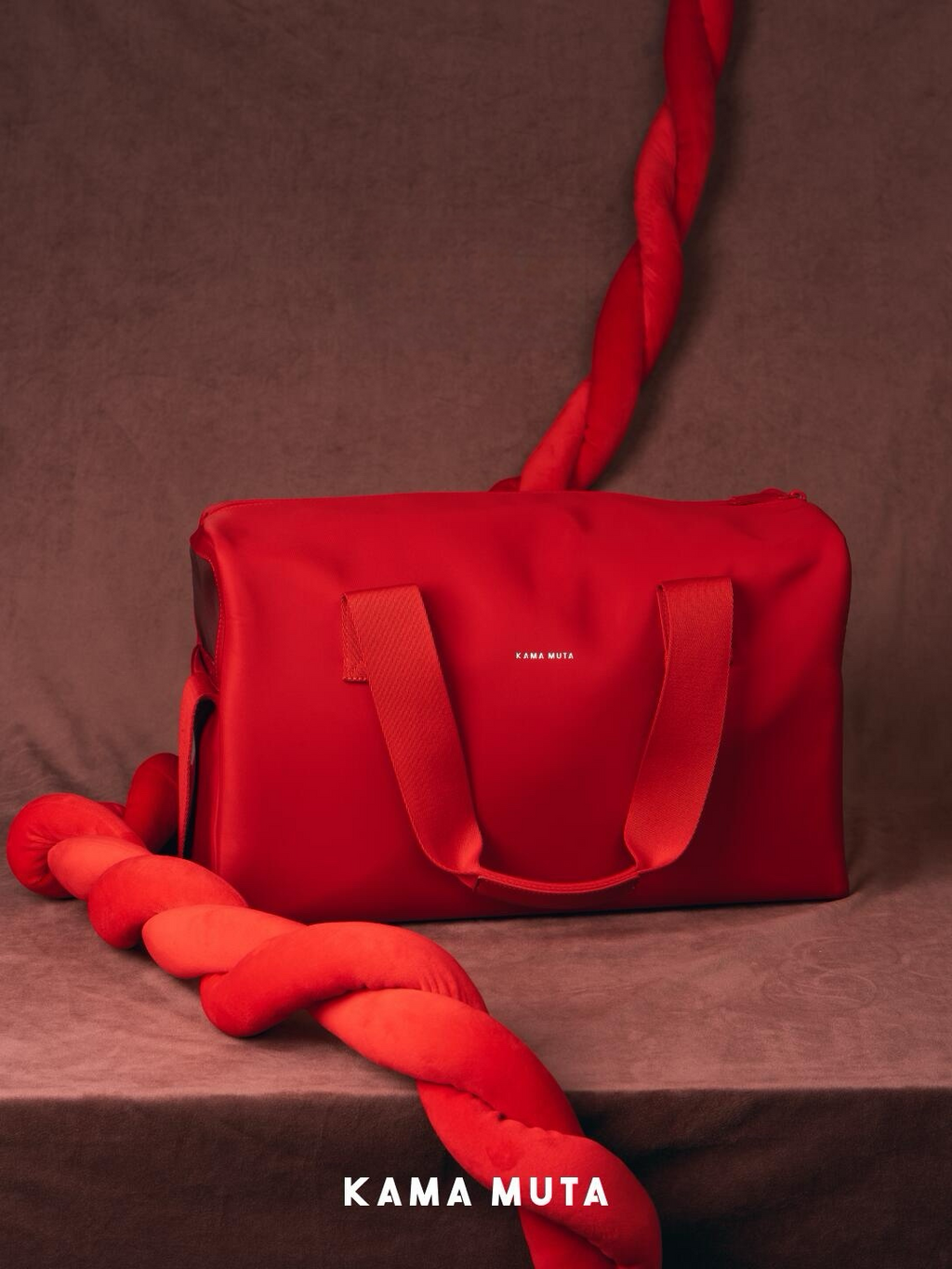 Red anti escape pet carrier bag displayed in a studio setting, highlighting a minimal and structured exterior design