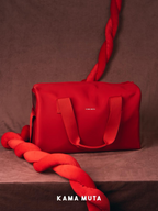 Red anti escape pet carrier bag displayed in a studio setting, highlighting a minimal and structured exterior design