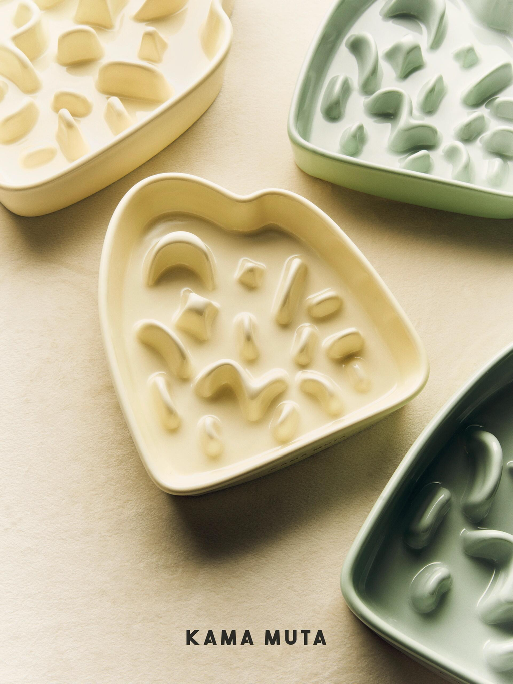 Multiple KAMA MUTA slow feeder bowls (cream and green) with unique maze designs