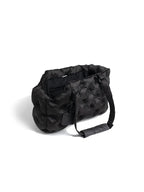Black dog carrier bag with a quilted, padded design, suitable for lightweight and warm pet travel.