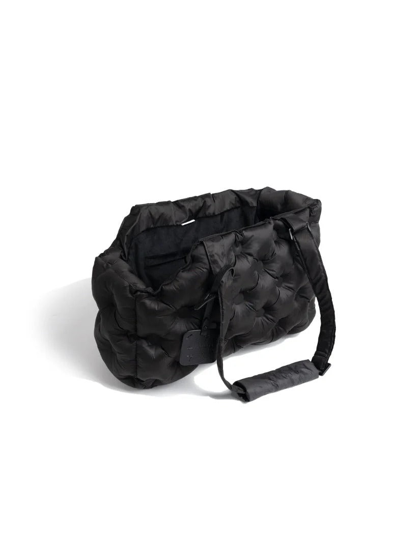 Black dog carrier bag with a quilted, padded design, suitable for lightweight and warm pet travel.