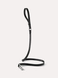 Minimalist black leather dog leash with slim profile and metal clasp, shown as a full-length product view.