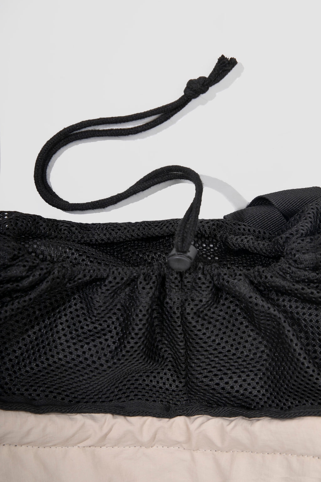 Detail of breathable mesh and drawstring system on a cat front carrier, allowing adjustable opening and secure fit