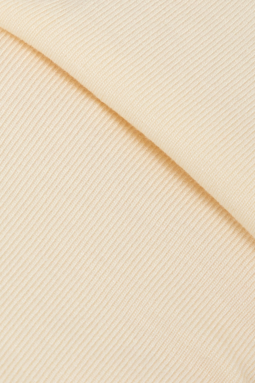 Macro texture shot of breathable stretch fabric used for a cat recovery suit, highlighting soft knit material for long wear comfort.