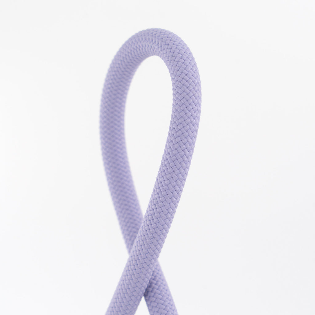 Close-up of a purple braided cord on a white background