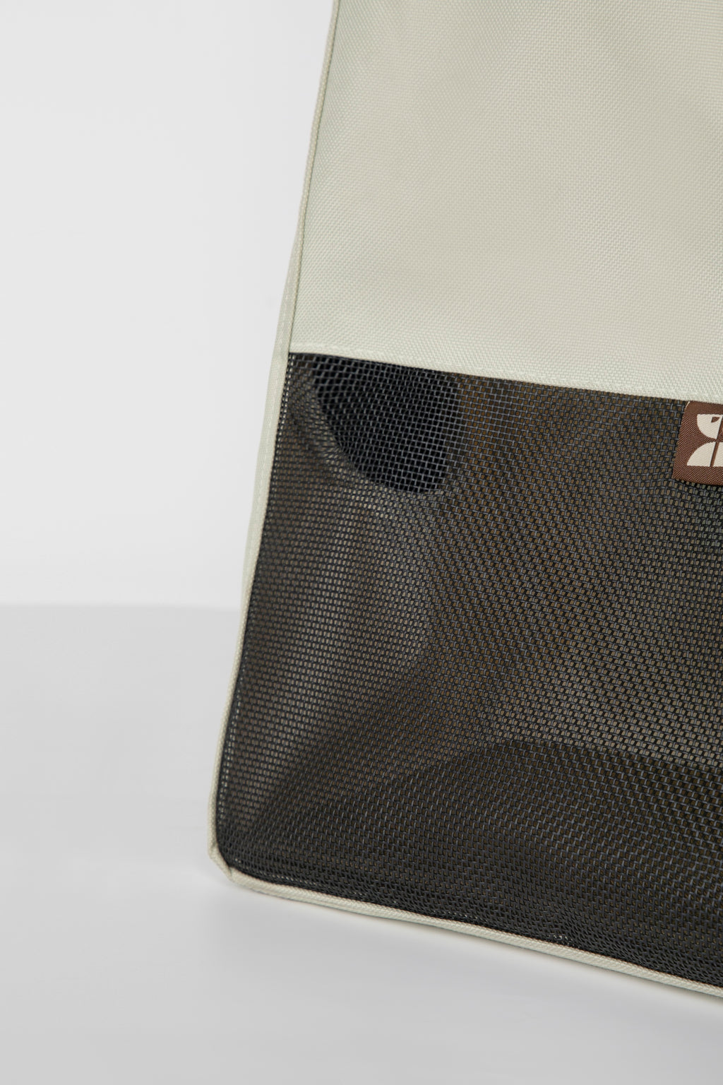 Close-up of the large front mesh window on a cat carrier tote, showing breathable nylon mesh that allows airflow and visibility.
