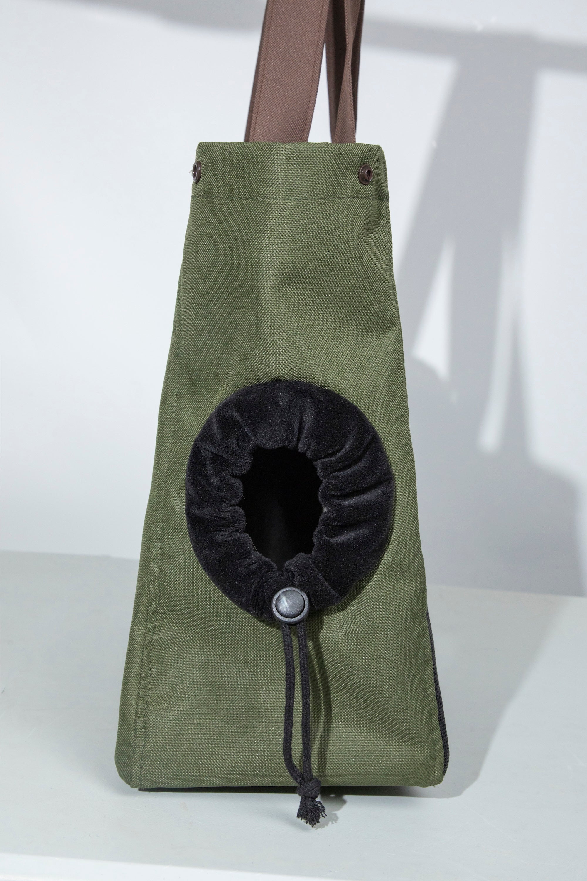  Back/side view of the cat carrier tote showing the side opening with a padded rim and adjustable drawcord for anti-escape control.