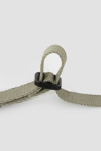 Detail of adjustable woven strap on the cat harness, featuring a plastic slider that allows precise size adjustment for a secure fit.