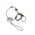 Flat lay of a cat harness and leash set with leather accents, showing the combination of braided rope, leather details, and metal hardware.