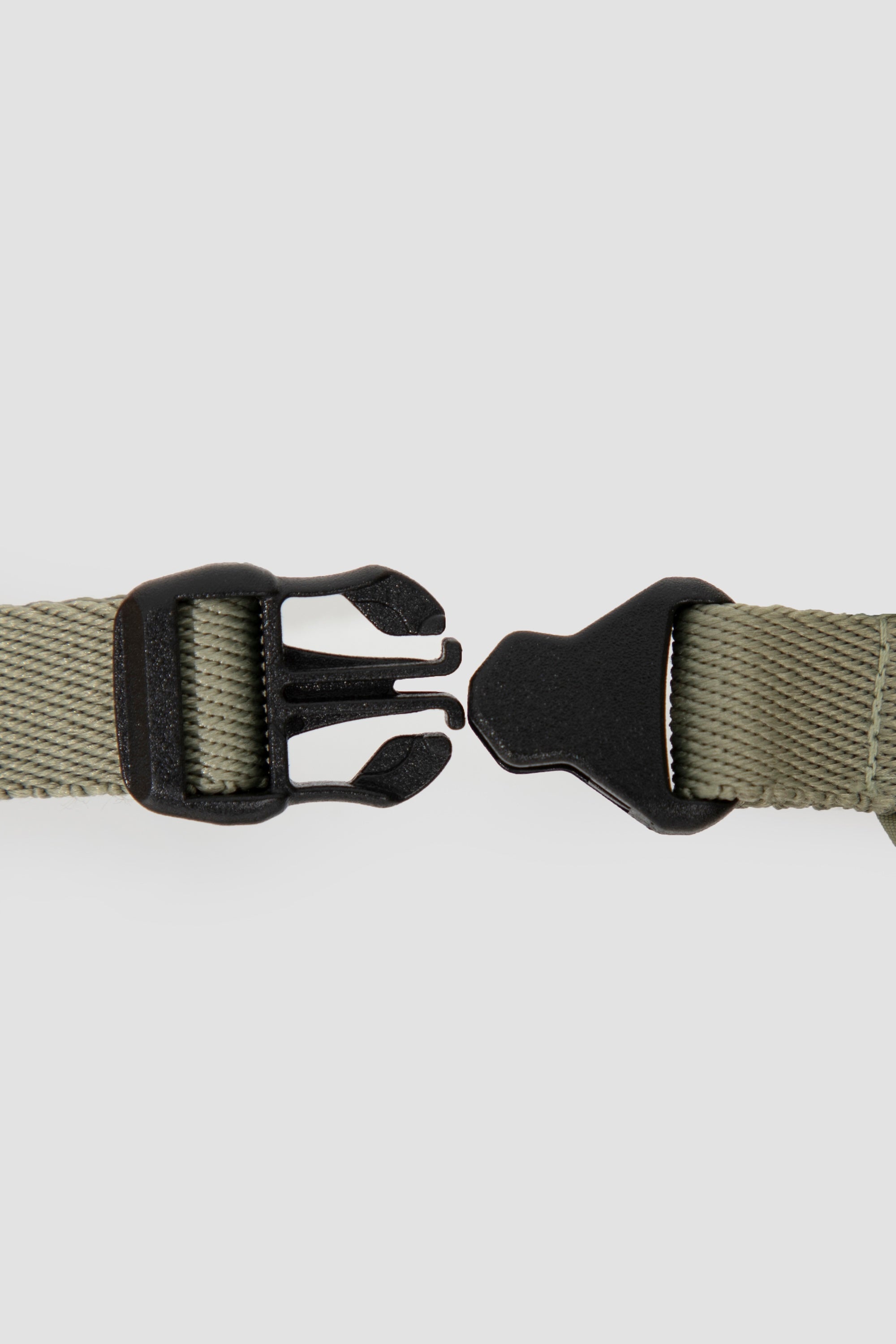 Close-up view of the quick-release buckle on the cat harness, showing the two-piece snap buckle used for easy on and off.