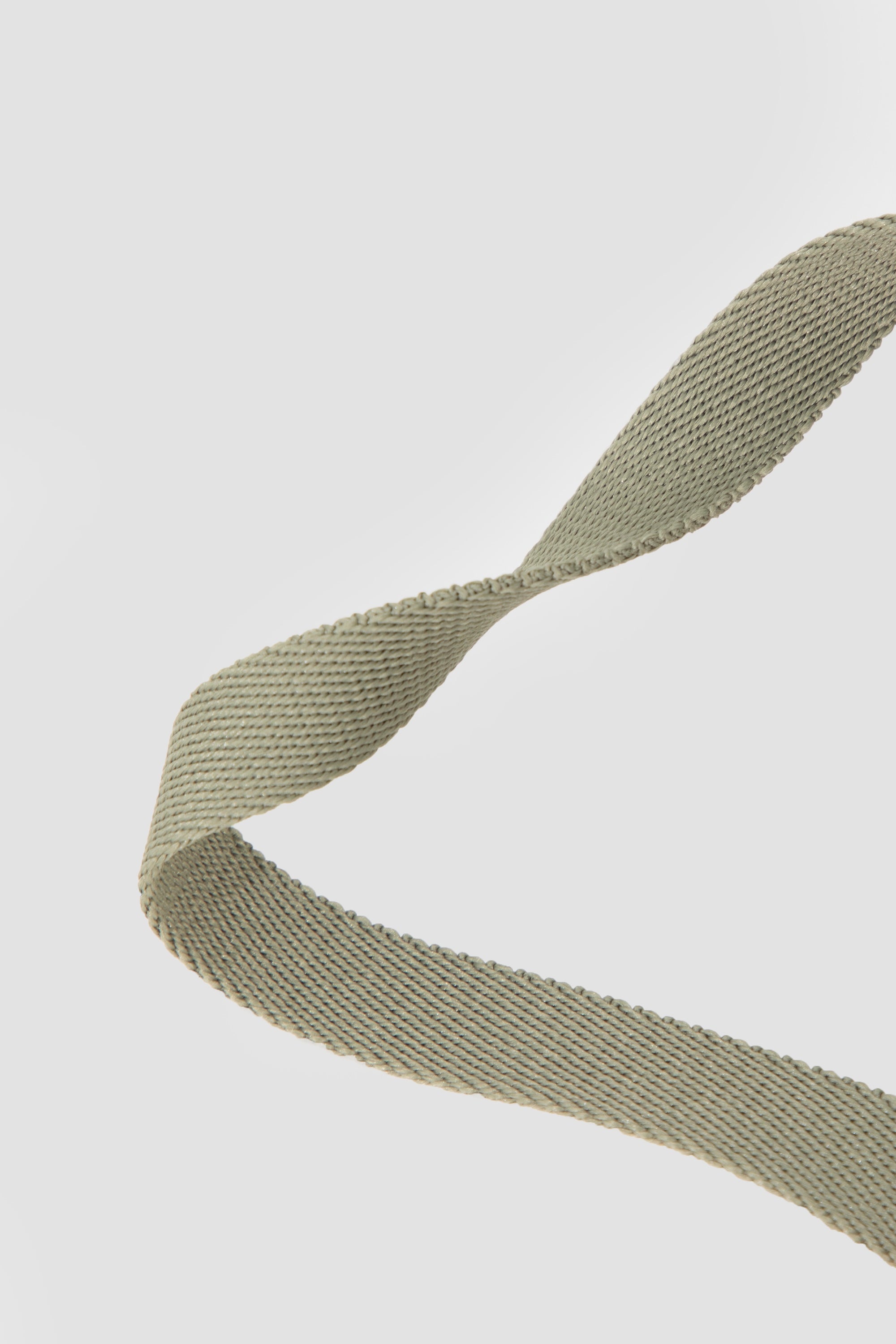 Close-up of olive cat leash webbing texture, showing the woven strap material and flexibility for a cat harness and leash set.
