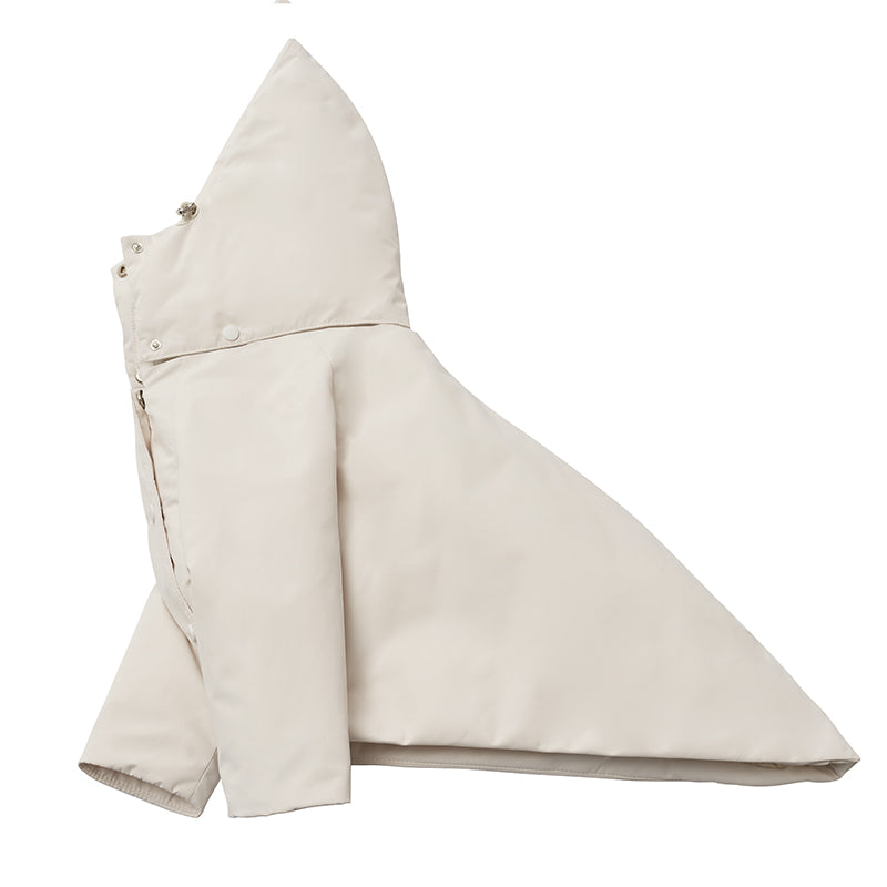 Flat lay of a cream dog down jacket highlighting the detachable hood and clean silhouette