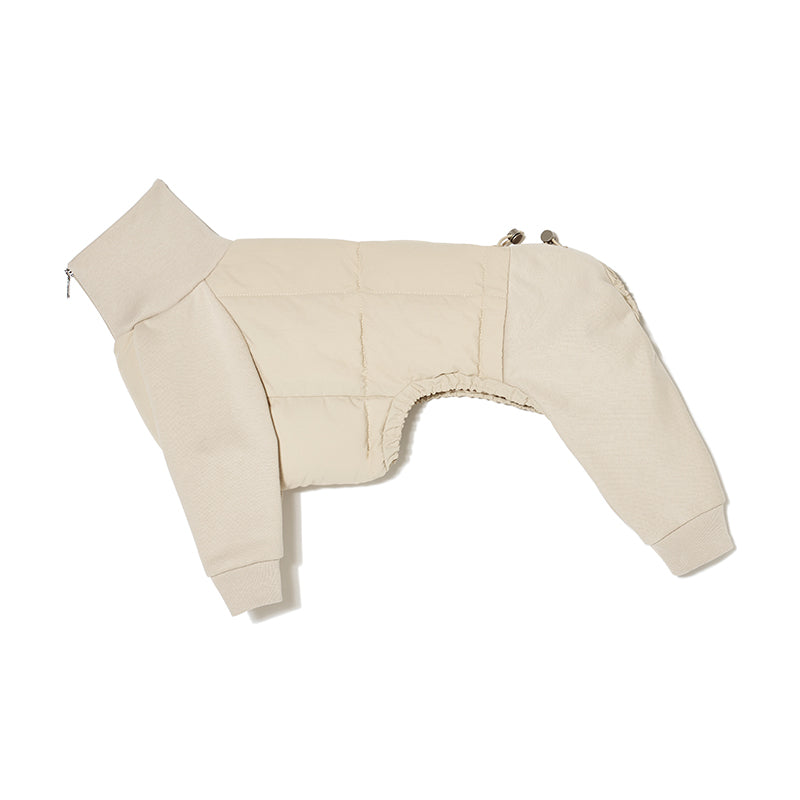Flat lay view of a cream-colored four-leg dog jacket displaying the overall structure and cut