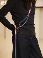 Crossbody hands-free dog leash worn across the back, featuring soft matte rope texture, adjustable hardware, and a vintage-inspired purple tone.