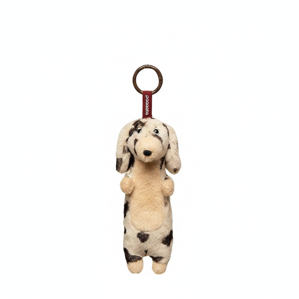 Soft plush Dachshund keychain by paaaata featuring a long-haired, dappled white design with detailed stitching and a keyring attachment.