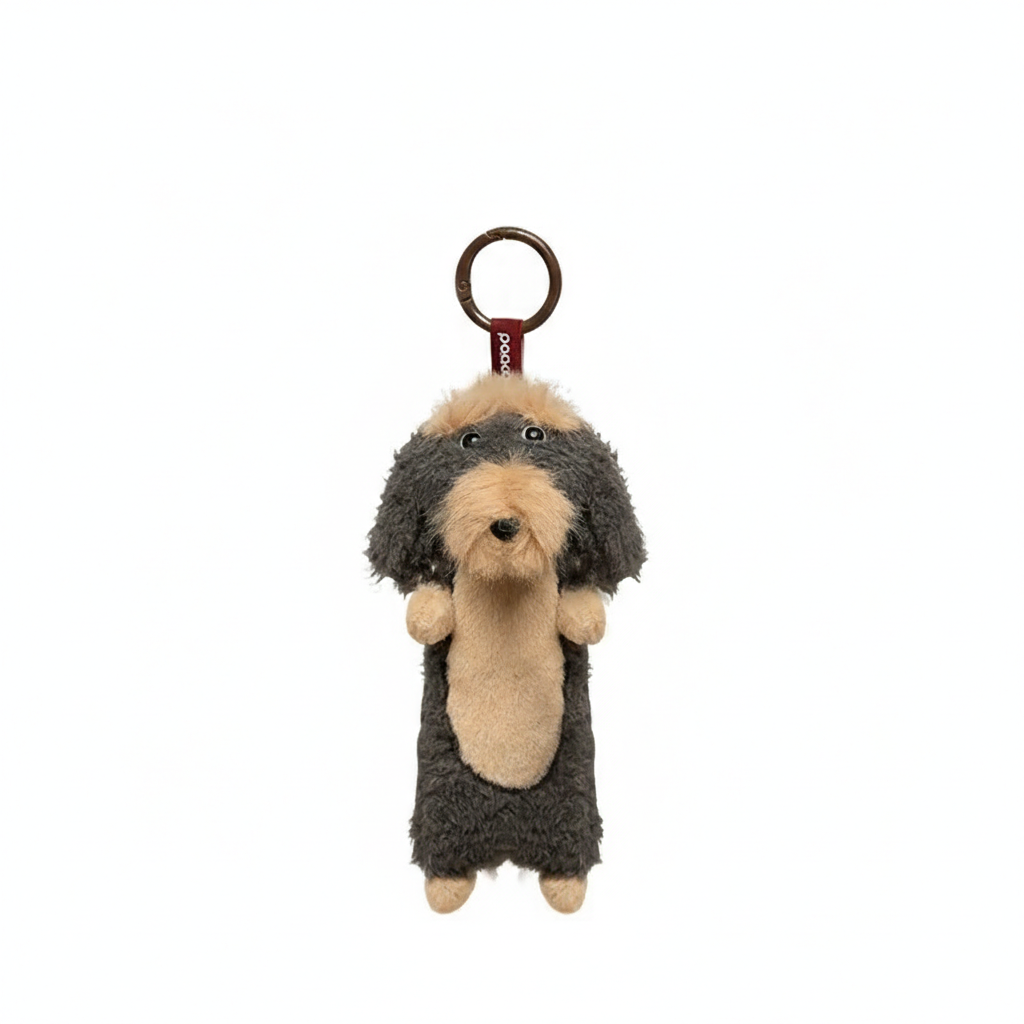 Gray long-haired Dachshund plush keychain by paaaata, featuring soft fabric and detailed dog design for key or bag attachment.