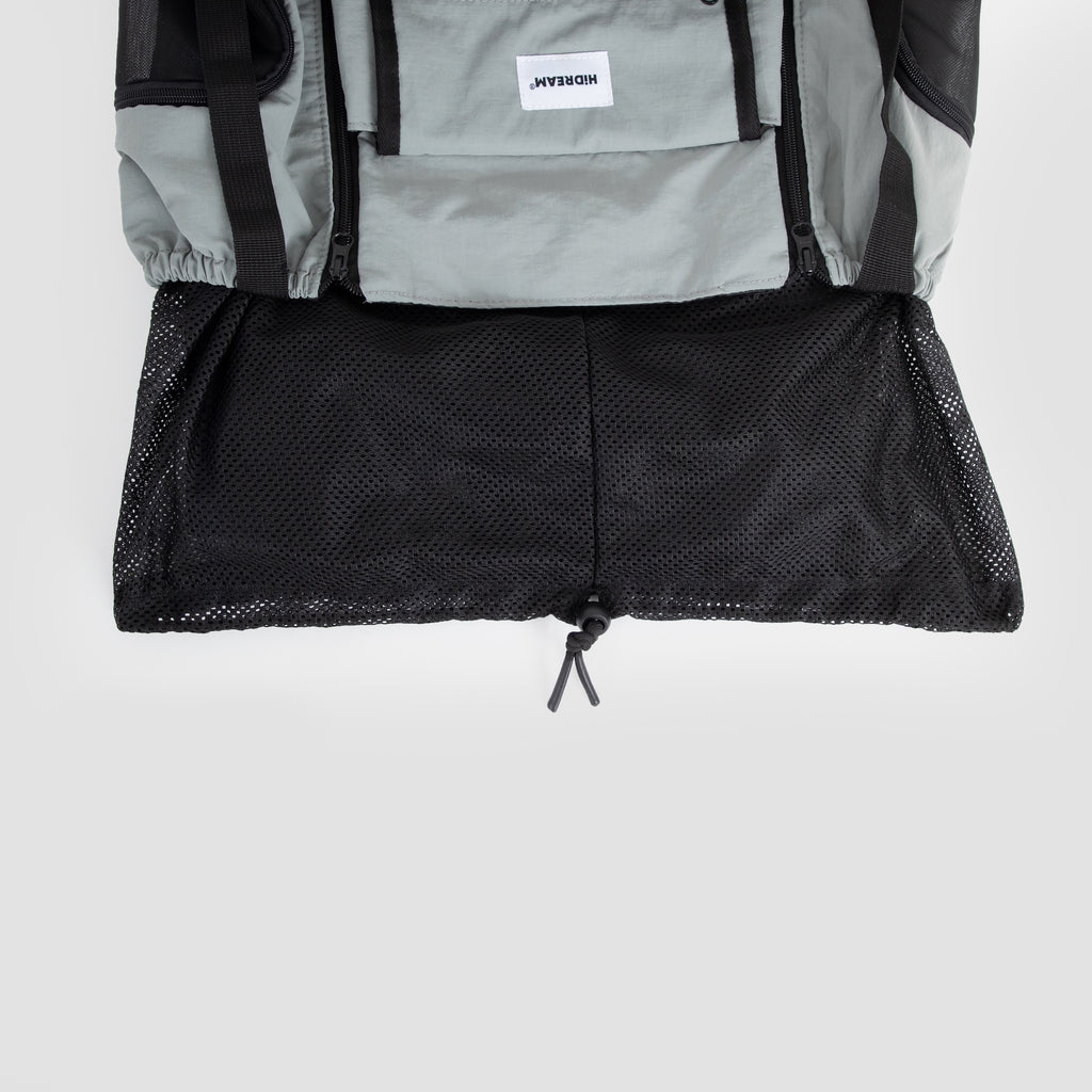 Bottom mesh panel of a dog front carrier bag shown fully opened, increasing ventilation and interior space.