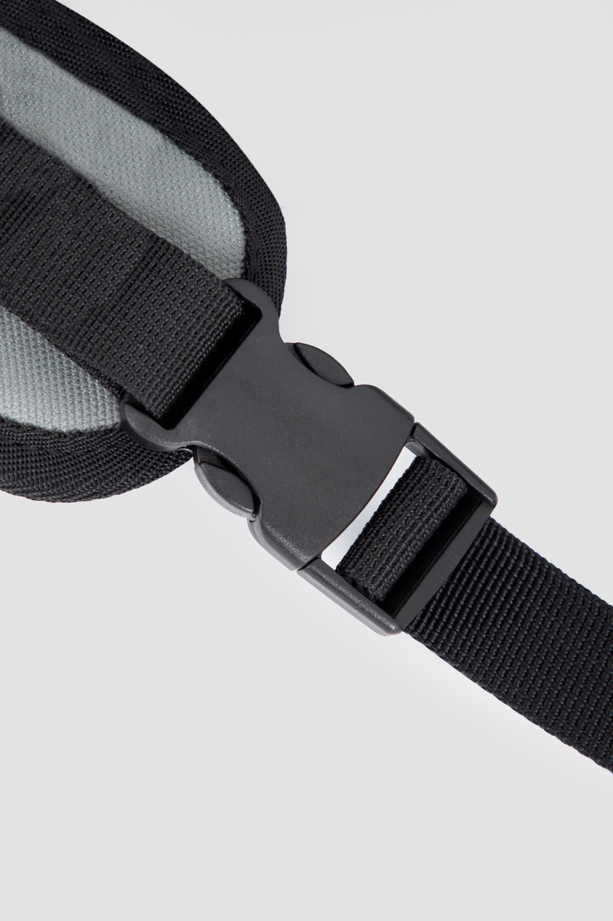 Close-up of the POM safety buckle on a dog front carrier bag, showing secure connection and adjustable strap structure.