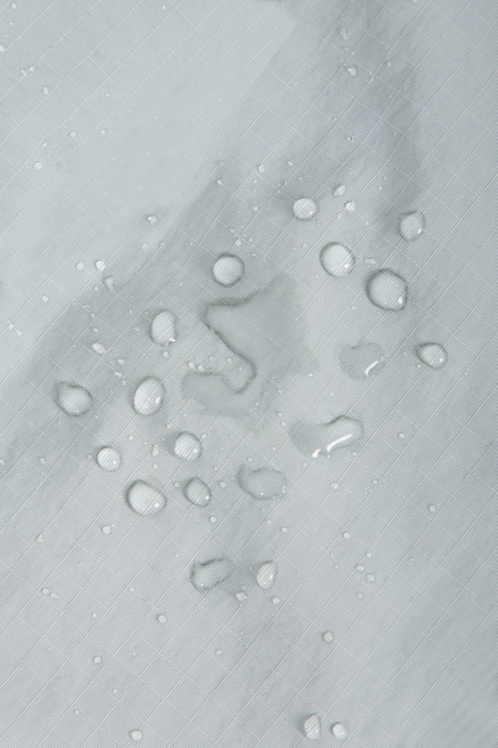 Close-up of waterproof nylon fabric on a dog front carrier bag, showing water resistance and easy-clean surface.