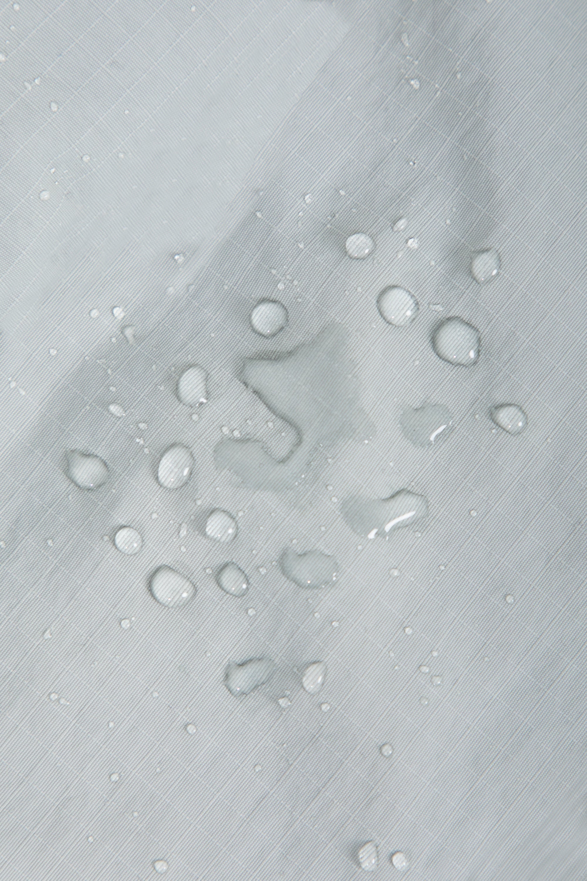 Close-up of waterproof nylon fabric on a dog front carrier bag, showing water resistance and easy-clean surface.