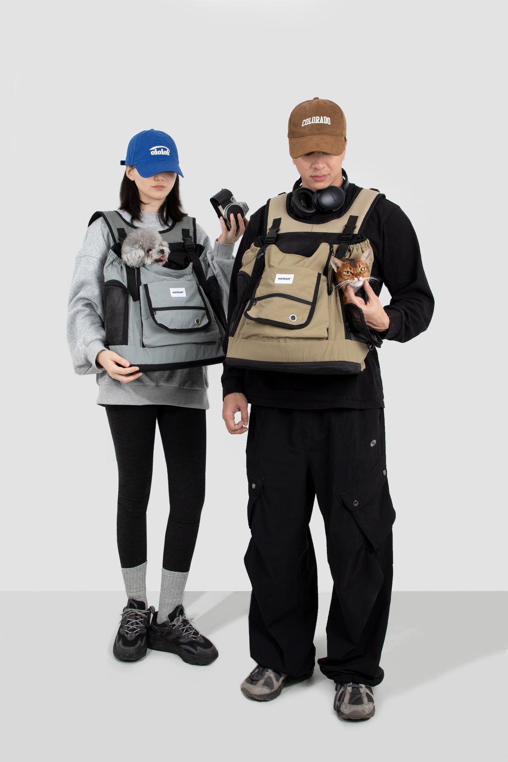 Two people wearing dog front carrier bags with pets inside, showing adjustable fit and suitability for different body types.