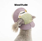 A poodle is shown from the back wearing a dog hat with wide brim and ear openings, highlighting lightweight fabric and structured stitching