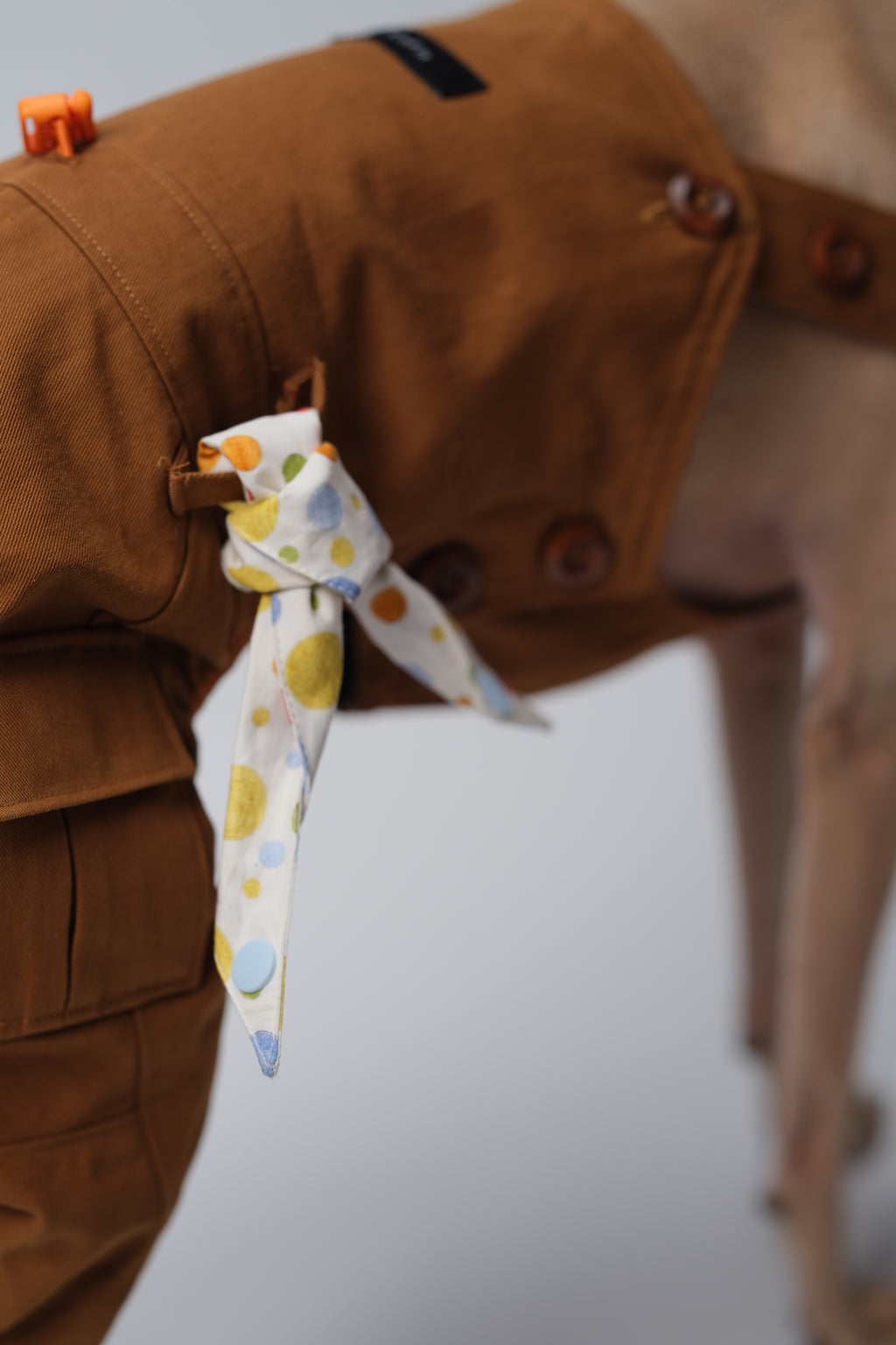 Cotton polka dot dog bandana paired with a brown overall for playful everyday styling