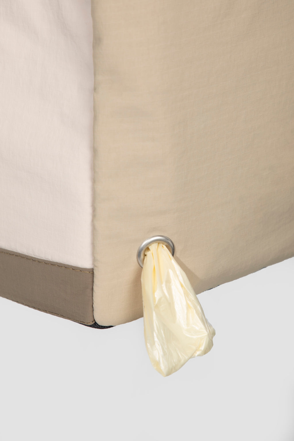 Side view of a dog tote bag with built-in waste bag dispenser, allowing quick access to bags during walks or outings.