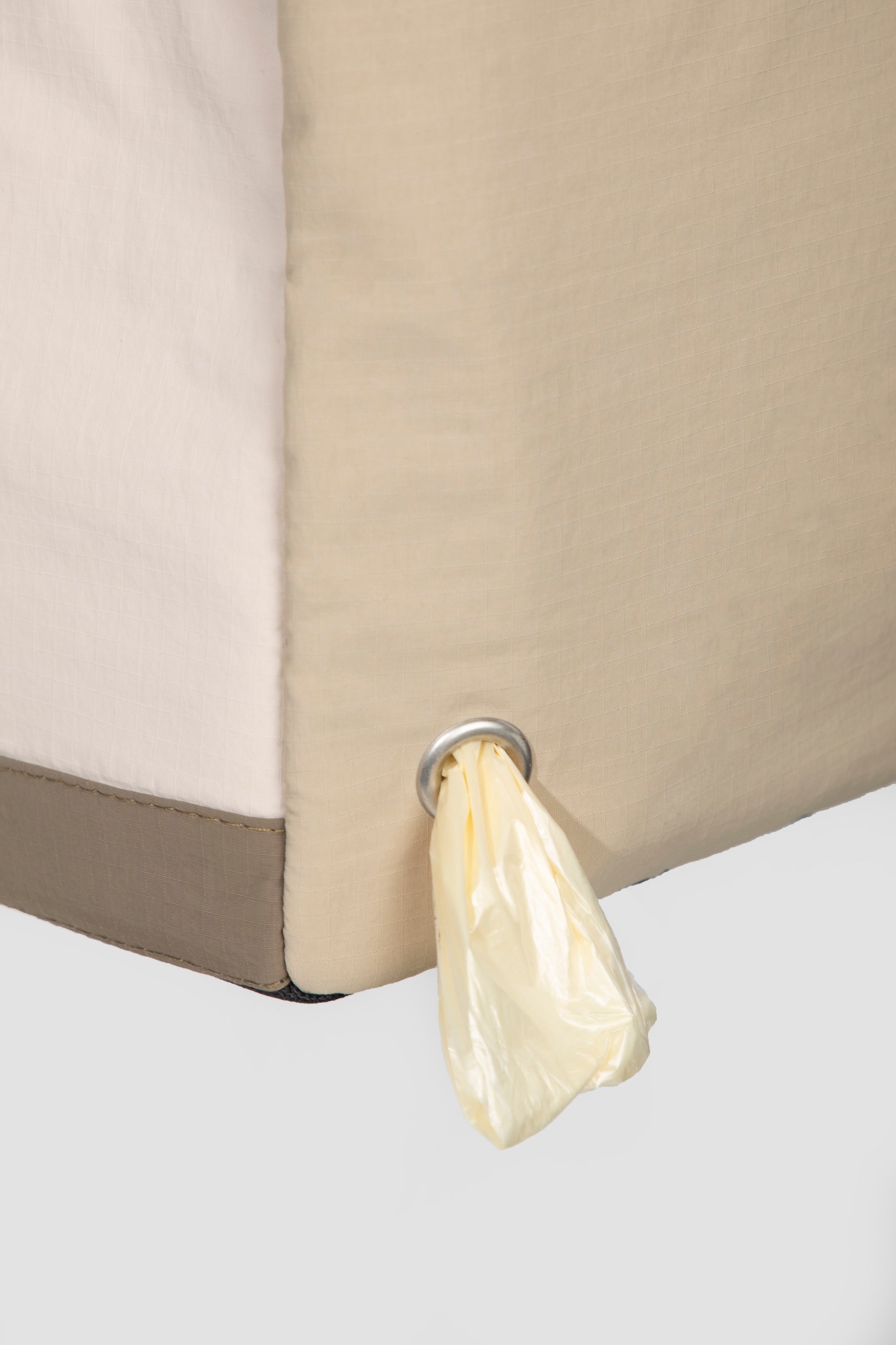 Side view of a dog tote bag with built-in waste bag dispenser, allowing quick access to bags during walks or outings.