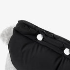 Close-up of removable decorative bolts on the back of a padded dog vest, combining functional fastening with minimalist design.