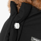 Close-up of removable decorative bolts on the back of a padded dog vest, combining functional fastening with minimalist design.