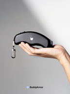 Black retractable dog leash resting on a person's open hand