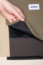 Close-up of the roll-up flap opened on a pet carrier backpack, revealing the inner mesh panel for breathable ventilation.