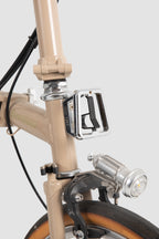 Close-up of the bicycle front frame and pedal area with a front bicycle pet carrier mounted above, showing how the pet bike bag fits with the bike structure.