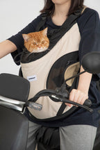 Front-facing cat carrier worn while cycling, showing stable fit, breathable mesh opening, and hands-free design for urban pet travel