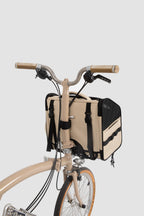 Angled view of a front-mounted pet bike bag installed on a small-wheel bicycle, showing secure attachment and compact proportions.