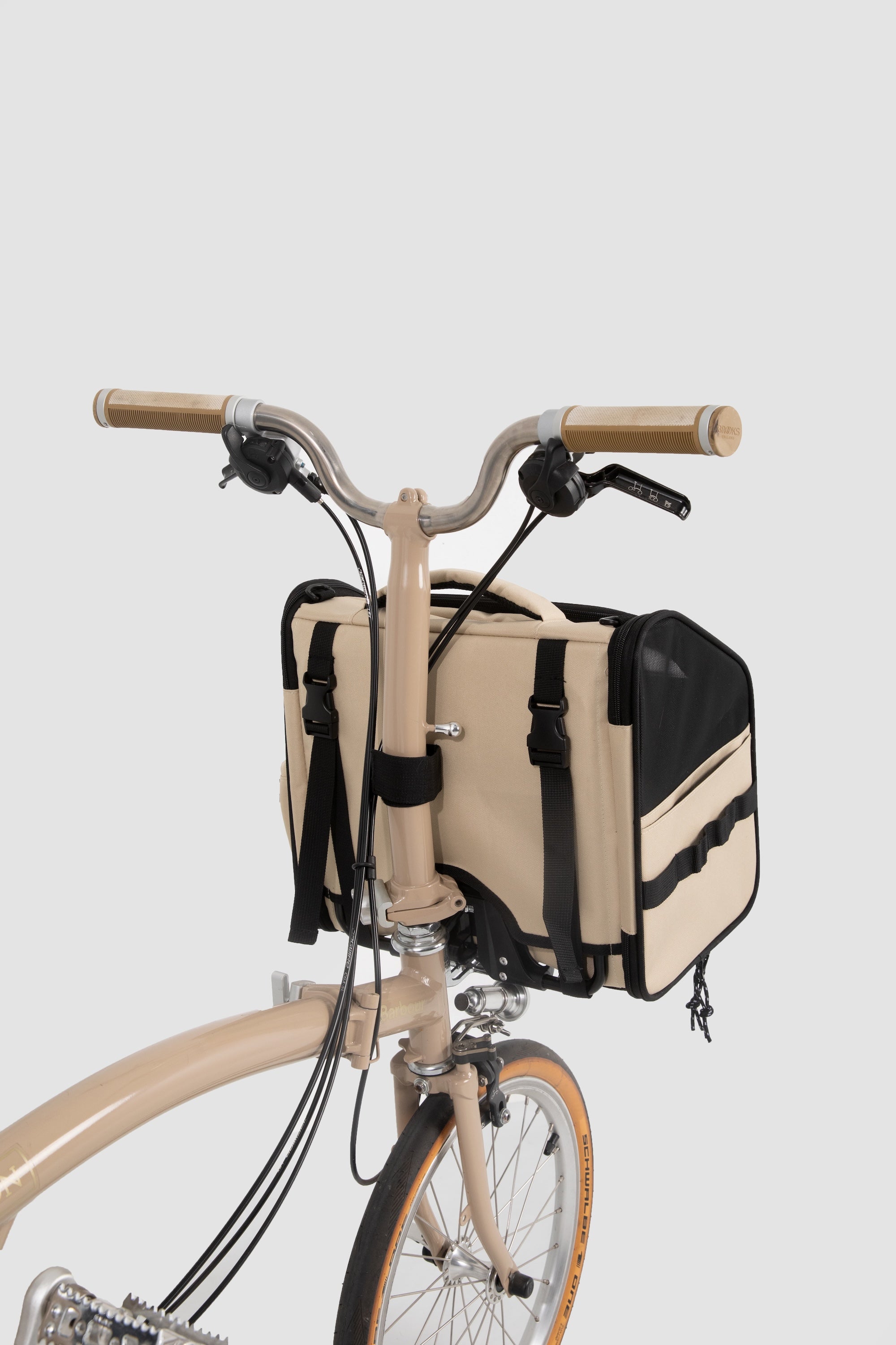 Angled view of a front-mounted pet bike bag installed on a small-wheel bicycle, showing secure attachment and compact proportions.