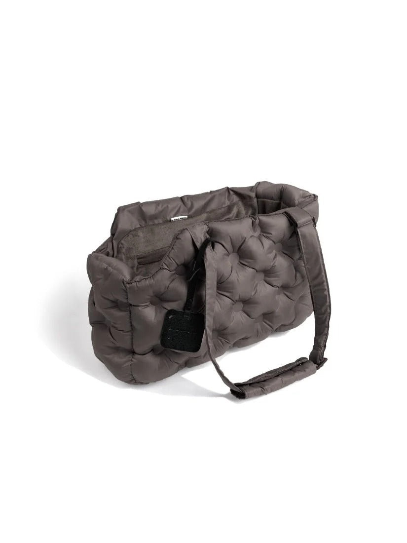 Minimal gray pet carrier bag featuring a soft padded structure for comfortable transport of small dogs.