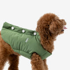 Green padded dog vest shown from the side, featuring a smooth fit and lightweight insulated design for everyday wear.