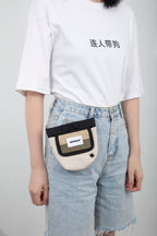  Side-angle view of a hands-free dog treat pouch worn on a waist belt, highlighting how the pouch sits against the body during walks.