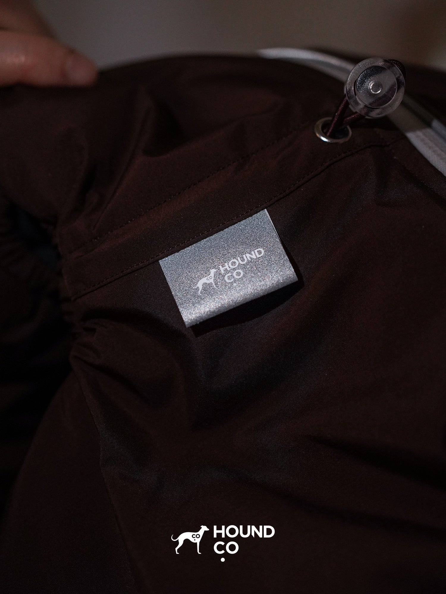 Detail shot of a reflective fabric label on a dog suit, designed to improve visibility in low-light conditions