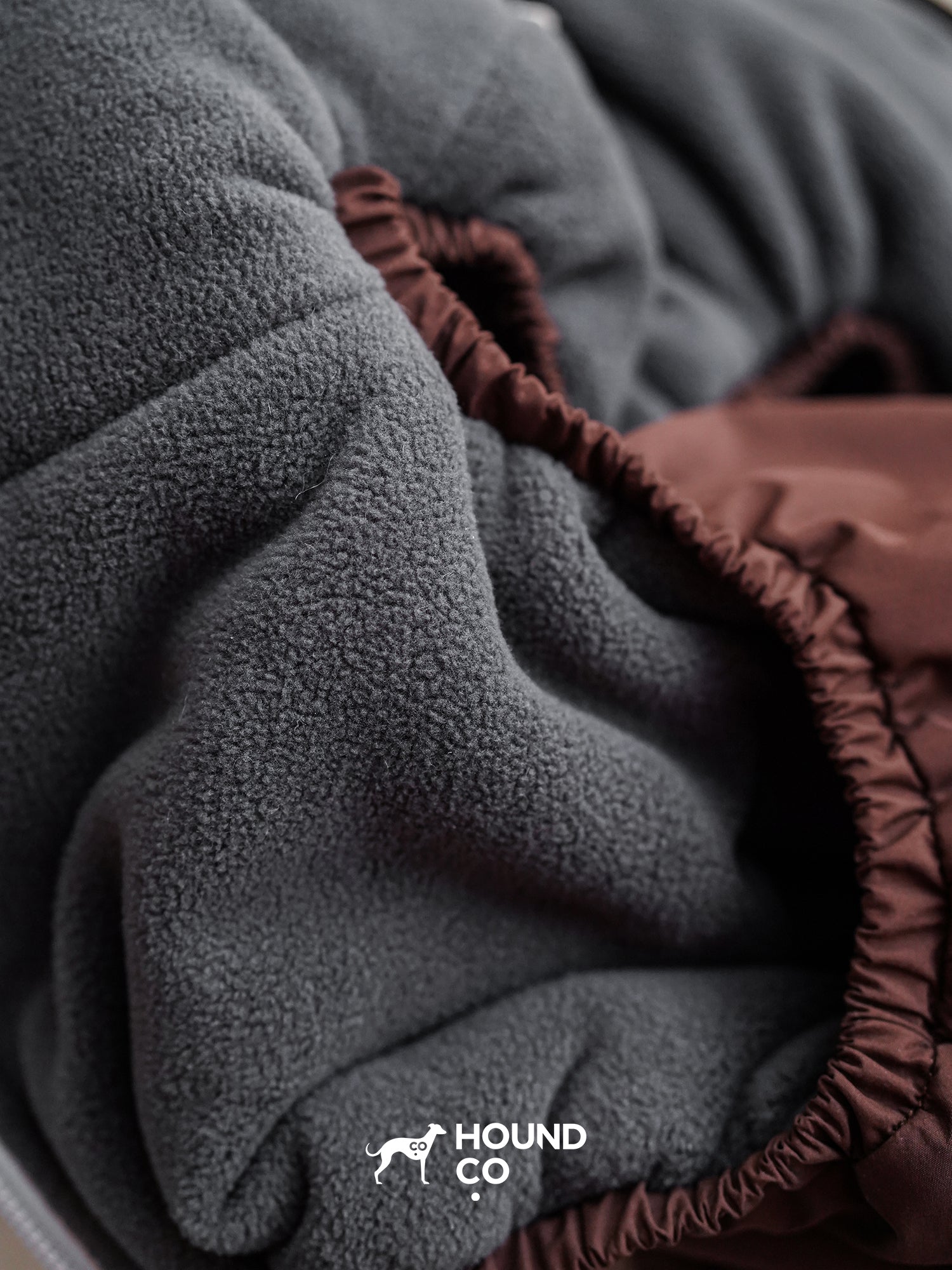 Macro view of the fleece interior fabric used inside a winter dog suit, showing thickness and softness