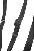 Black GENTLEBEAST dog leash displayed on a textured surface, showcasing its durable material and sturdy clip.